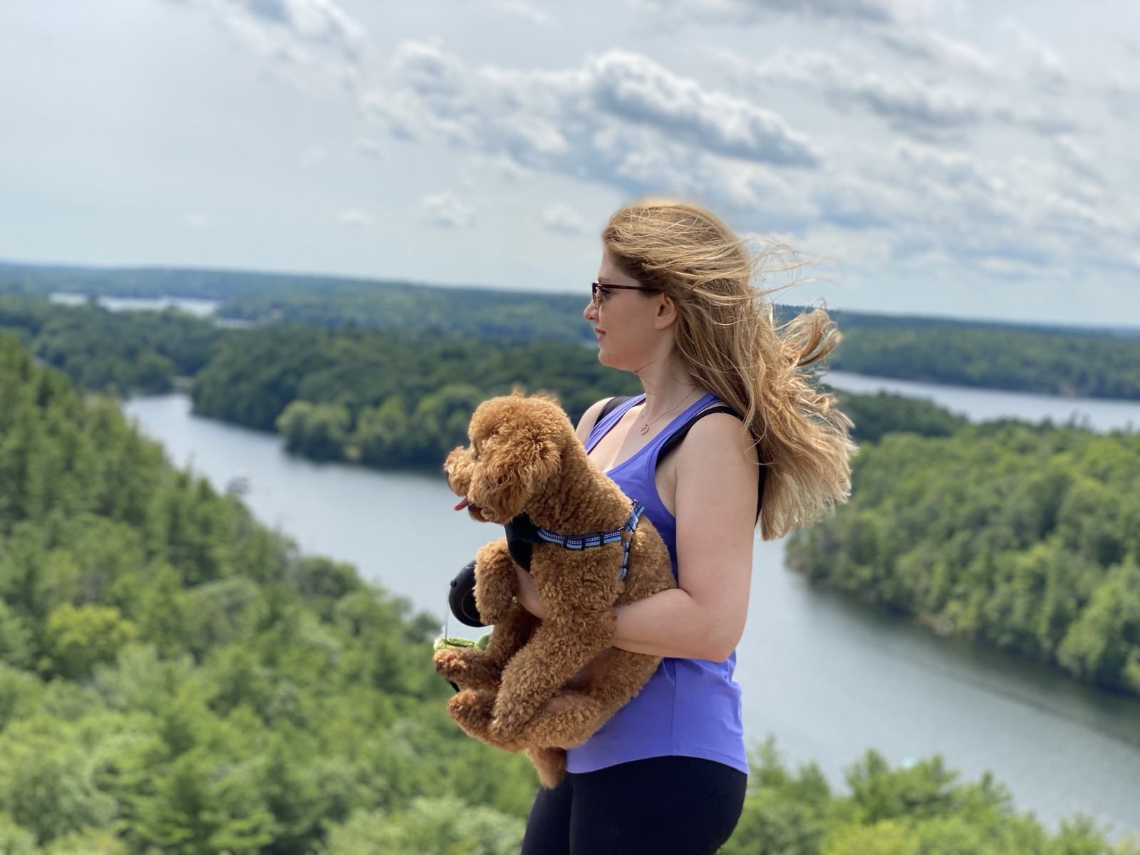 Lily and her dog Simba on a hike overlooking a lake